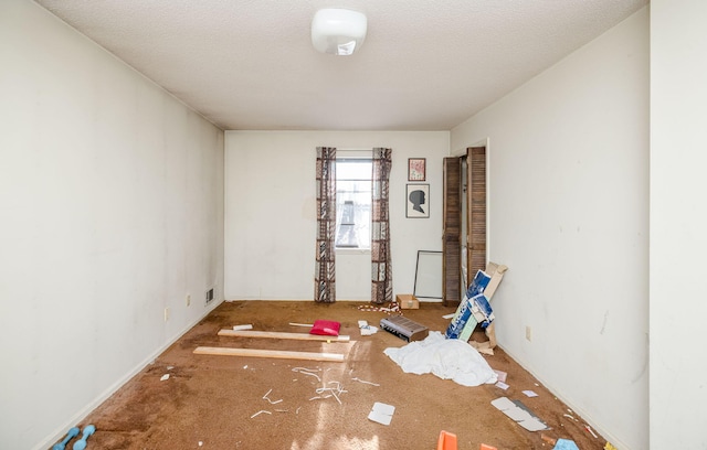 spare room with visible vents and a textured ceiling