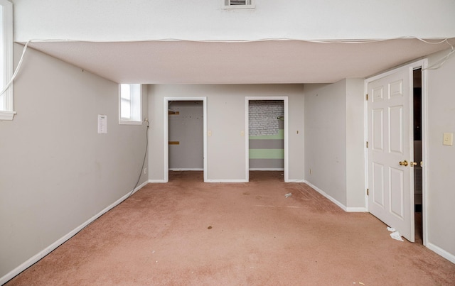 interior space with light carpet, visible vents, and baseboards