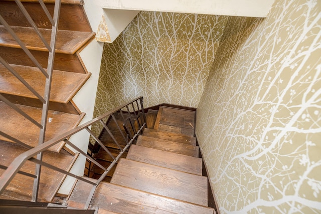 staircase featuring wallpapered walls