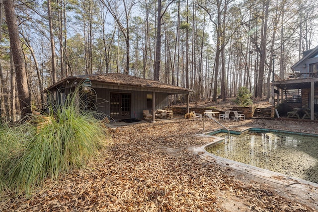 exterior space featuring an outbuilding and an outdoor pool