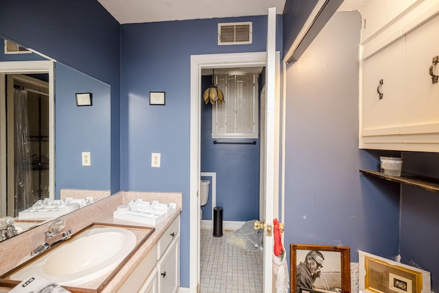 full bath with baseboards, visible vents, toilet, tile patterned floors, and vanity