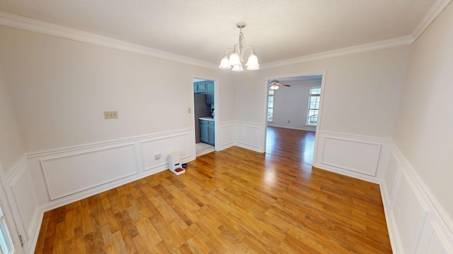 3904 Loblolly Trl, Martinez, GA 30907 - unfurnished room with a chandelier, ornamental molding, a decorative wall, light wood-style floors, and a wainscoted wall