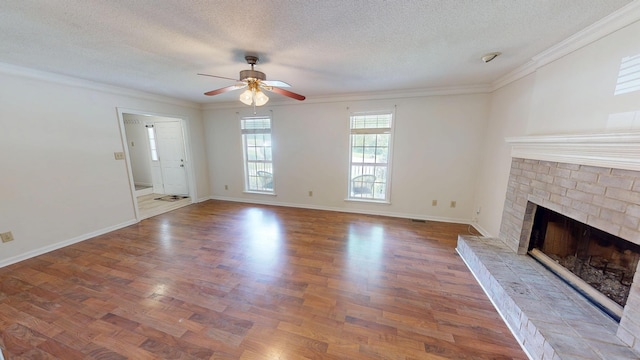 3904 Loblolly Trl, Martinez, GA 30907 - unfurnished living room featuring ceiling fan, a textured ceiling, a fireplace, ornamental molding, and wood finished floors