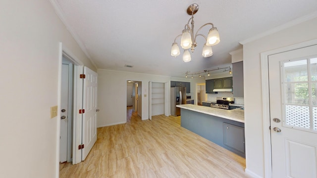 3904 Loblolly Trl, Martinez, GA 30907 - kitchen featuring appliances with stainless steel finishes, crown molding, a peninsula, under cabinet range hood, and a chandelier