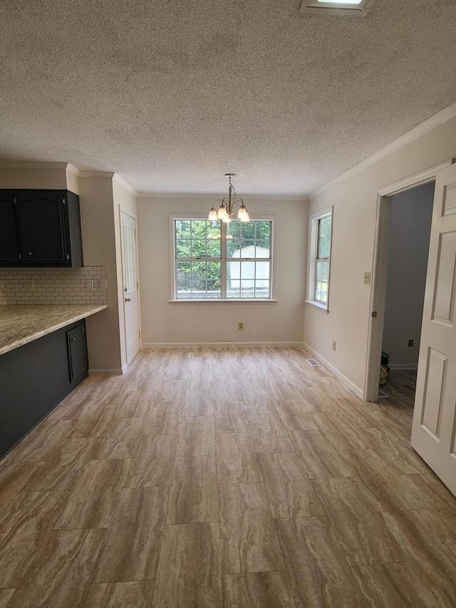 3904 Loblolly Trl, Martinez, GA 30907 - unfurnished dining area with a chandelier, crown molding, a textured ceiling, and light wood finished floors