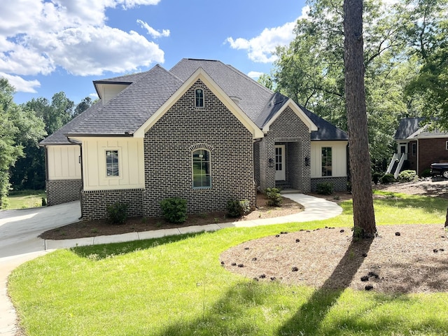 191 Devonshire Dr, Aiken, SC 29803 - view of front facade featuring board and batten siding, brick siding, a shingled roof, and a front yard
