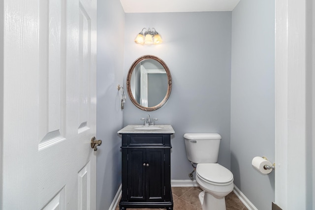 bathroom with vanity, tile patterned floors, and toilet