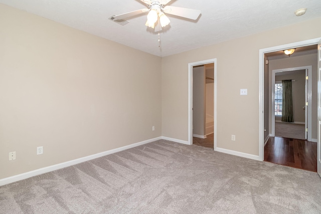 unfurnished bedroom with light colored carpet and ceiling fan