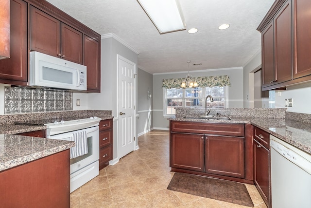 kitchen with pendant lighting, sink, white appliances, and crown molding