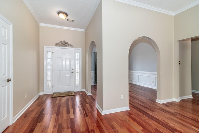 foyer featuring crown molding and dark hardwood / wood-style floors