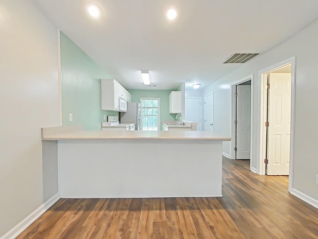 9025 Baker Ct, Augusta, GA 30909 - kitchen featuring white appliances, light countertops, white cabinets, and dark wood-style floors