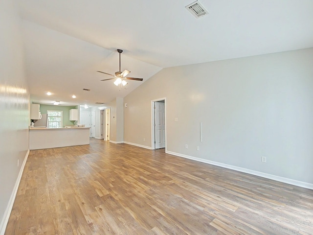 9025 Baker Ct, Augusta, GA 30909 - unfurnished living room with light wood-style flooring, a ceiling fan, baseboards, and vaulted ceiling