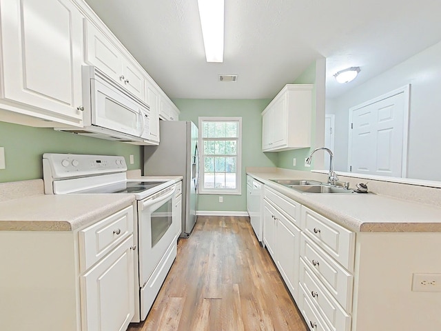 9025 Baker Ct, Augusta, GA 30909 - kitchen featuring white appliances, a sink, light wood finished floors, white cabinets, and light countertops