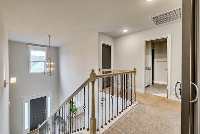 736 Courtland Ln, Harlem, GA 30814 - corridor featuring carpet, an inviting chandelier, visible vents, an upstairs landing, and baseboards
