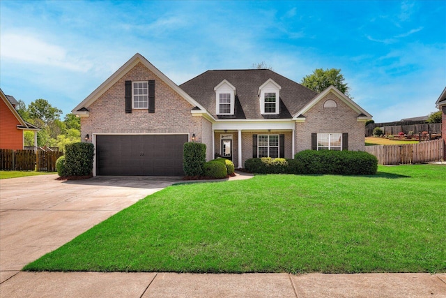 view of front of house with driveway, a front lawn, an attached garage, brick siding, and fence