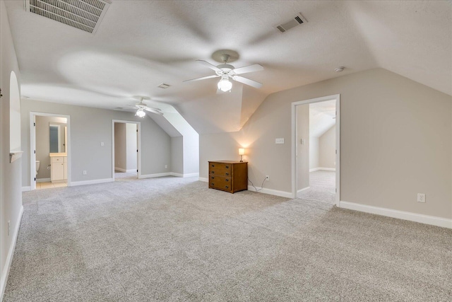 bonus room featuring lofted ceiling, a ceiling fan, and visible vents