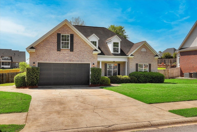 view of front of property featuring brick siding, fence, and an attached garage