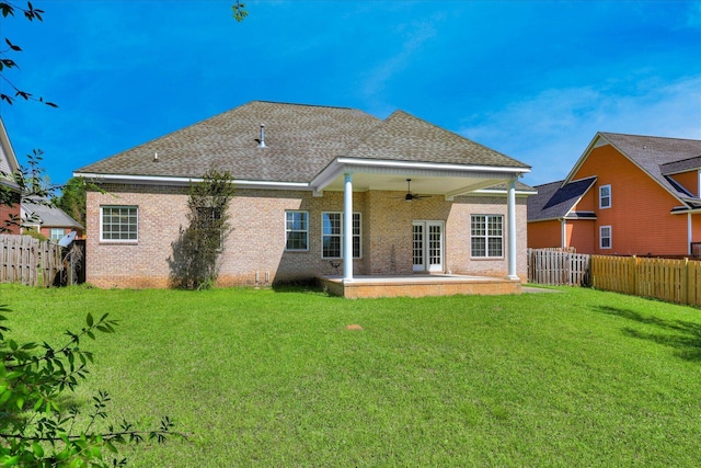 rear view of property featuring a yard, a patio area, a fenced backyard, and a ceiling fan