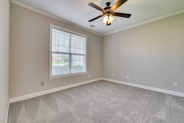 spare room featuring crown molding, visible vents, baseboards, and carpet floors