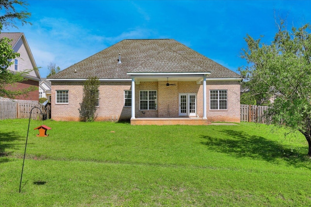 rear view of house with a yard, a ceiling fan, a fenced backyard, a patio, and brick siding