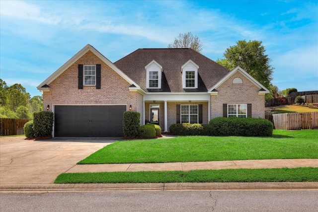 view of front facade featuring brick siding, a front lawn, fence, and an attached garage