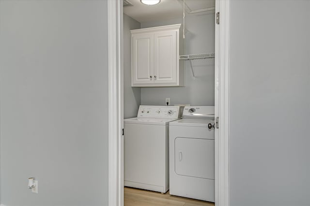 2120 Whitney S Dr, Augusta, GA 30904 - laundry area featuring washer and dryer, cabinet space, and light wood-type flooring