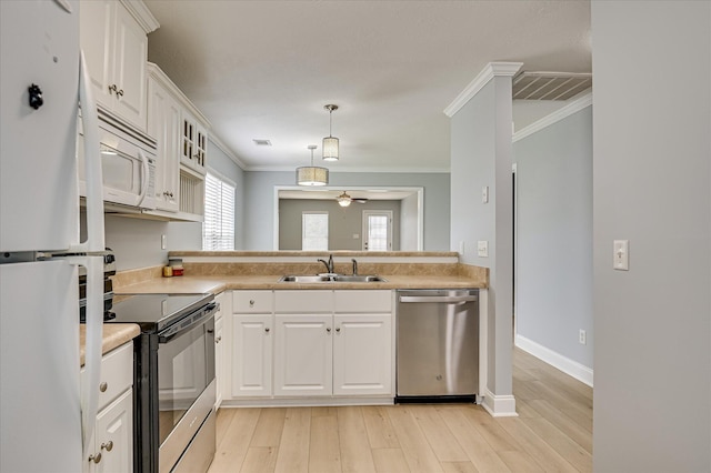2120 Whitney S Dr, Augusta, GA 30904 - kitchen featuring stainless steel appliances, ornamental molding, white cabinets, light countertops, and light wood-type flooring
