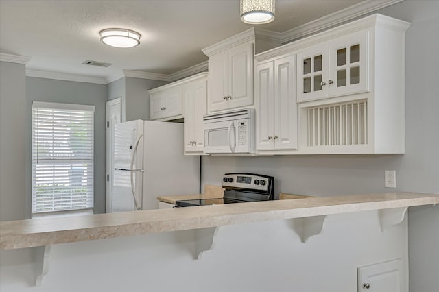 2120 Whitney S Dr, Augusta, GA 30904 - kitchen featuring white appliances, a breakfast bar area, glass insert cabinets, light countertops, and white cabinets