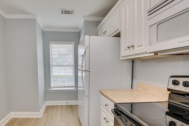 2120 Whitney S Dr, Augusta, GA 30904 - kitchen featuring white appliances, light wood finished floors, ornamental molding, white cabinets, and light countertops
