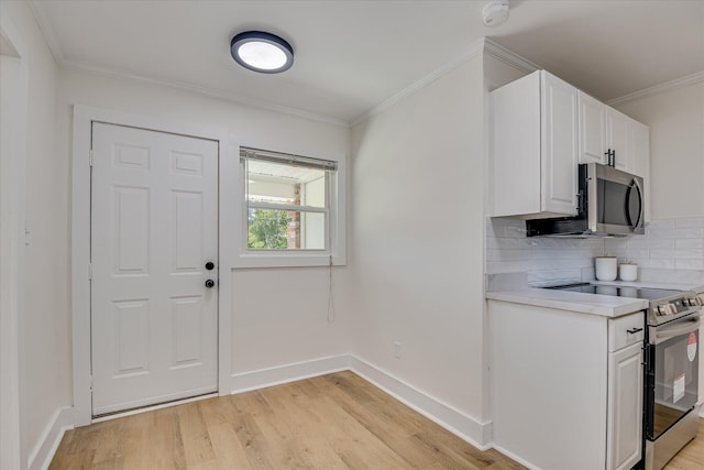 2281 Raleigh Dr, Augusta, GA 30904 - kitchen with stainless steel appliances, light countertops, ornamental molding, backsplash, and white cabinetry