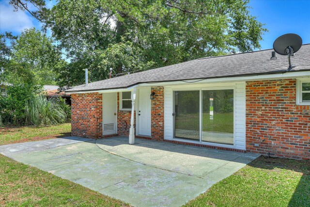 2281 Raleigh Dr, Augusta, GA 30904 - back of house with brick siding, a patio area, and roof with shingles