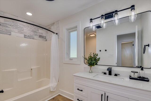 2281 Raleigh Dr, Augusta, GA 30904 - bathroom featuring vanity, shower / bath combo with shower curtain, wood finished floors, and baseboards