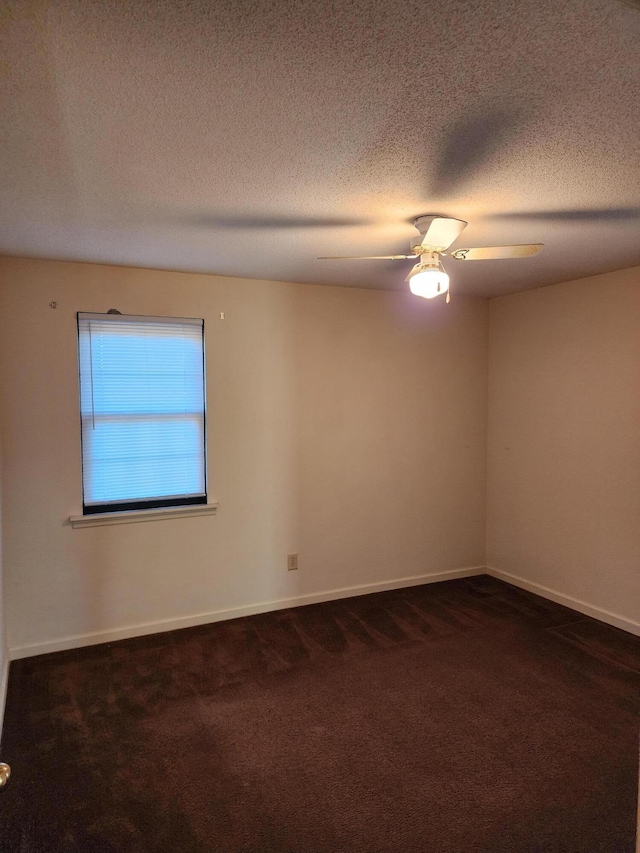 3747 Crest Dr, Hephzibah, GA 30815 - spare room featuring dark colored carpet, a ceiling fan, baseboards, and a textured ceiling