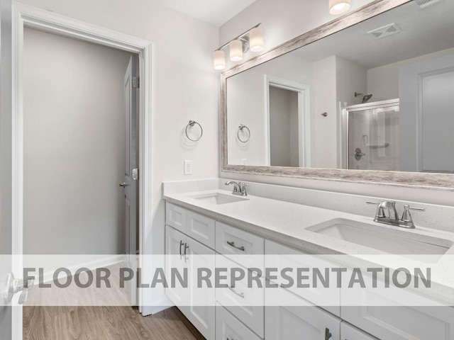 1307 Newbern Dr, Grovetown, GA 30813 - bathroom featuring double vanity, a shower stall, and wood finished floors