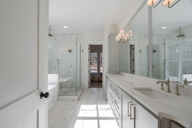 bathroom featuring vanity, a notable chandelier, and independent shower and bath