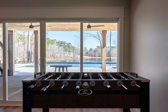 recreation room featuring a healthy amount of sunlight and a water view