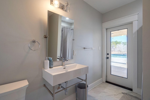 bathroom featuring sink and toilet