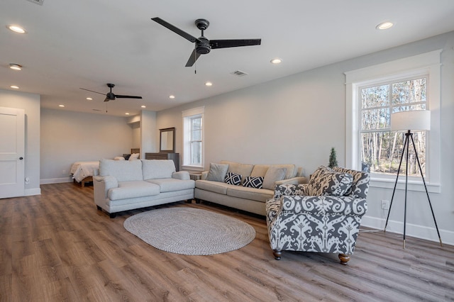 living room with hardwood / wood-style floors and ceiling fan