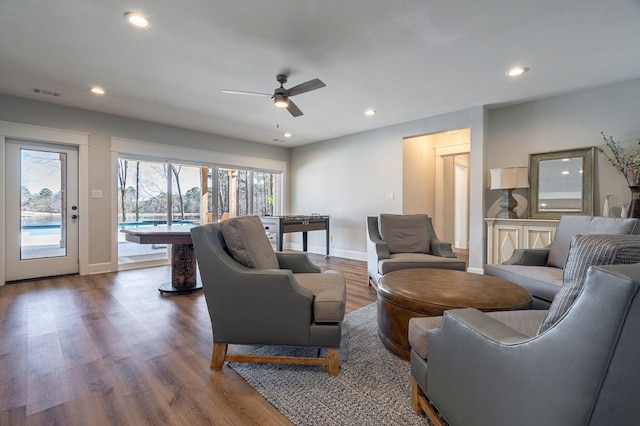 living room featuring ceiling fan and hardwood / wood-style floors