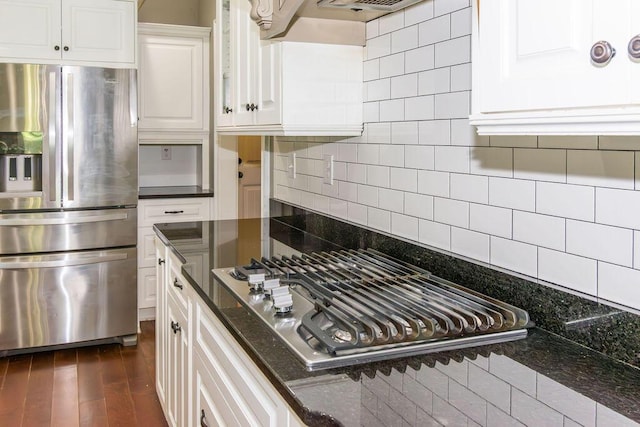 322 Pump House Rd, Evans, GA 30809 - kitchen featuring appliances with stainless steel finishes, white cabinets, decorative backsplash, dark stone counters, and dark wood-style floors