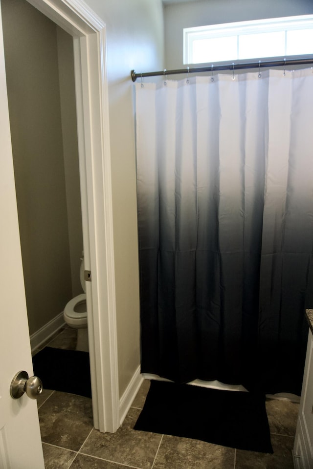 4042 Cottingham Way, Augusta, GA 30909 - bathroom with toilet, baseboards, and a shower with shower curtain