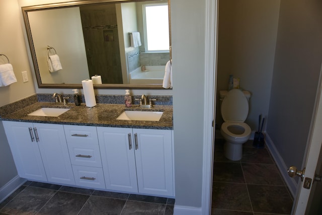 4042 Cottingham Way, Augusta, GA 30909 - bathroom featuring a garden tub, double vanity, baseboards, toilet, and a shower with shower door