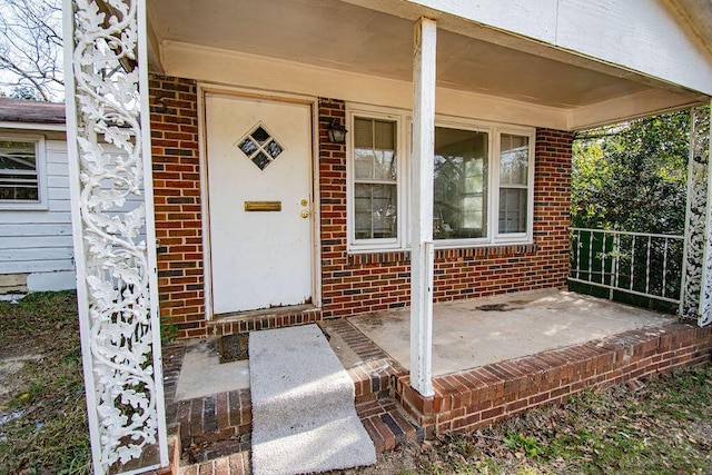 entrance to property featuring brick siding