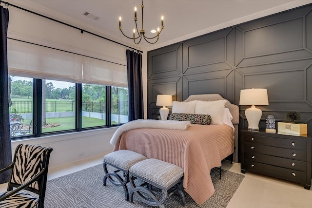 bedroom with an inviting chandelier, visible vents, and a decorative wall