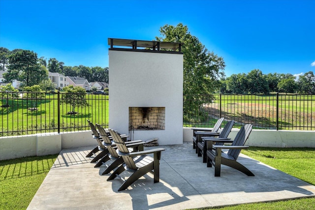 view of patio / terrace with fence and an outdoor fireplace