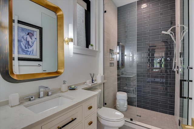 bathroom with a stall shower, vanity, and toilet