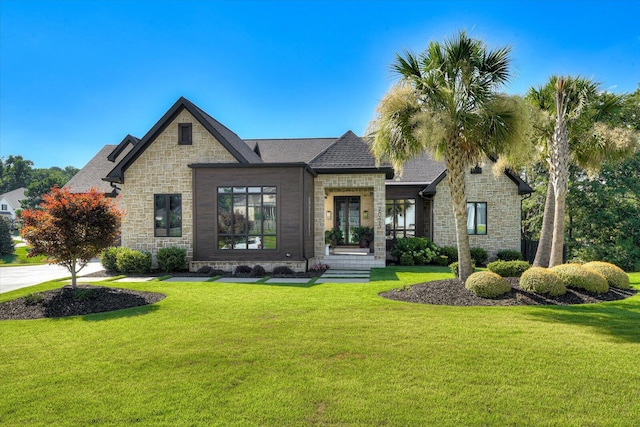 view of front of home featuring stone siding and a front lawn