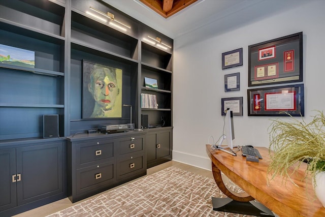 office space featuring built in shelves and baseboards