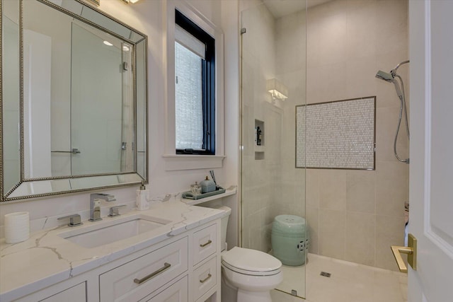 bathroom featuring toilet, walk in shower, and vanity