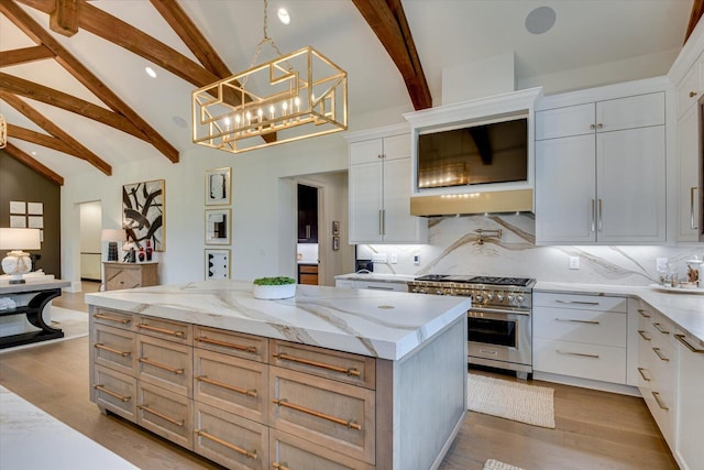 kitchen with a center island, high end stove, backsplash, and wood finished floors